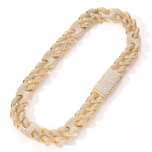 Macro shot of 20mm gold iced out Cuban chain necklace with sparkling cubic zirconia