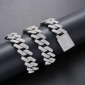Silver cuban link chain necklace with iced out cubic zirconia stones on black stand
