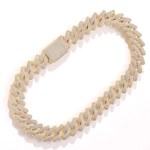 Close-up of golden Cuban link necklace with pave set zircons and rectangular buckle