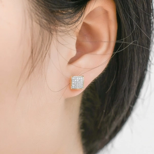 Minimalist square hip hop stud earrings in gold with pavé crystals on male model