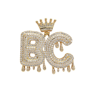 Detail of hip hop BC bubble letter pendant with gold crown and iced out stones