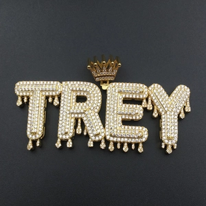 Detailed macro view of the gold plated hip hop pendant with TREY letters and crown