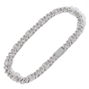 Macro detail of 15mm Cuban link chain with pave set baguette and round diamonds