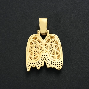 Detail of a hollow geometric gold lung pendant with intricate cutout patterns