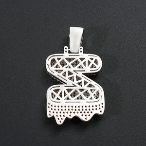Close-up of hip hop silver metal S-shaped pendant with hollow frame and lava drip design