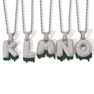 Detailed macro view of hip hop bubble letters with zircon stones and green lava drips