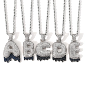 Macro detail of silver-toned hip hop bubble letter pendants with blue drip effect