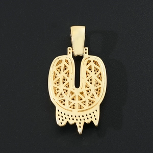 Detail of gold hip hop letter pendant showing back geometric hollow lattice and cz settings