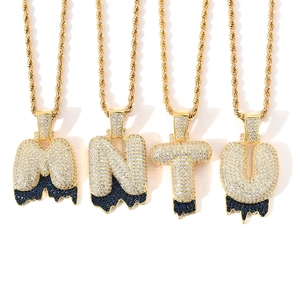 Detail view of hip-hop bubble letters M N T U with blue lava zircon and gold rope chain