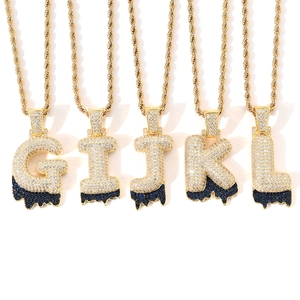 Close-up of hip hop gold letter pendants G to L with blue lava zircon settings and rope chains