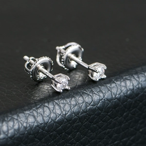 Detailed macro shot of S925 sterling silver four-prong stud earrings with screw backs