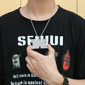 Detailed view of silver Black Lives Matter hip hop pendant with baguette zircon stones