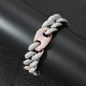 Macro detail of 20mm hip hop cuban chain with two-tone finish and paved zircon stones
