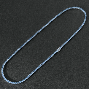 Macro detail of silver tennis chain with 4mm light blue zircon and box clasp closure