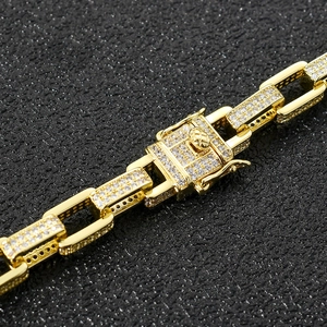 Close-up of gold iced out box chain links with cubic zirconia and security clasp