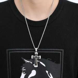 Detail of silver twisted rope chain with a black and white rhinestone cross pendant