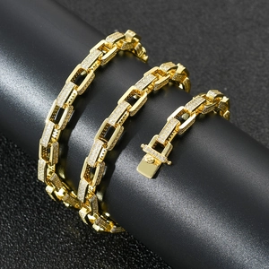 Macro view of gold hip-hop chain with micro-pave cubic zirconia on black stand