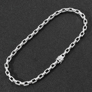 Macro shot of a silver iced-out box chain with cubic zirconia links and a secure clasp