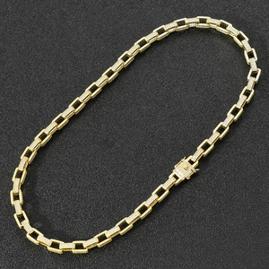 Macro view of gold plated hip hop chain with pave cubic zirconia and square buckle clasp