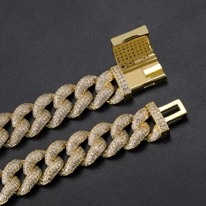 Macro shot of 12mm gold iced out Cuban chain with micro paved zircon on lock clasp
