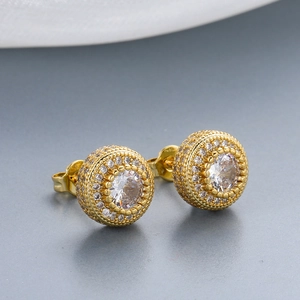 Macro shot of gold-plated hip hop stud earrings with pave-set sparkling zircon stones