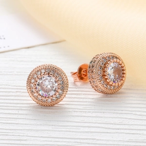Macro view showing round rose gold hiphop earrings with micro-paved cubic zirconia stones