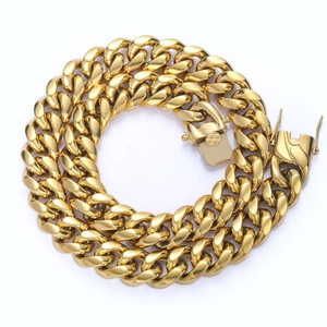 Macro detail of golden Cuban link necklace with dual-locking industrial clasp