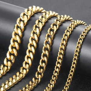Detail showing five different widths of gold Cuban link chains on a black display stand