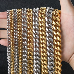 Macro comparison of different widths for gold and silver Cuban link chains on a hand