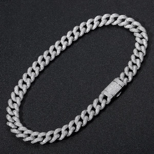 Macro shot of 15mm silver Cuban link chain with micro-pave cubic zirconia and iced out buckle