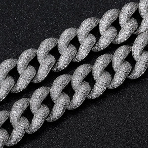 Macro shot of 15mm silver Cuban link necklace with pavé set zircon stones