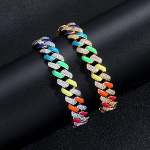 Detail of gold and silver 12mm Cuban link bracelets with rainbow enamel and zircon stones