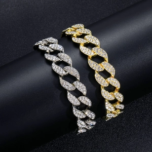 Detail of 15mm gold and silver Cuban link chains with dense pave-set rhinestones