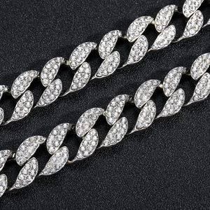 Macro shot of 15mm silver Cuban link chain featuring dense pave-set crystals for men