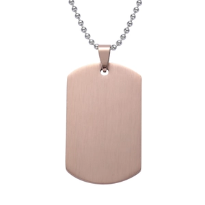 Detail of rose gold dog tag pendant with brushed metal texture and silver ball chain