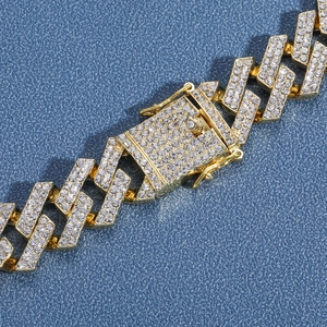 Macro detail of 19mm gold plated cuban link chain with iced out pavé setting stones