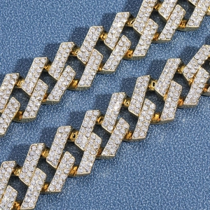 Macro shot of gold-plated 19mm Cuban link chain with paved shimmering crystals