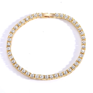 Classic golden tennis bracelet with round crystal rhinestones on a white background