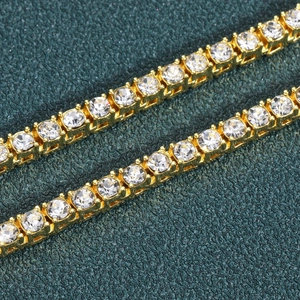 Macro detail of golden tennis chain with sparkling round-cut crystals in 4-prong setting