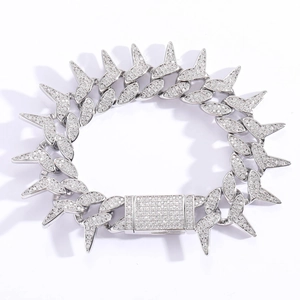 Macro detail of silver hip hop Cuban bracelet with spiked links and micro-pave zircons