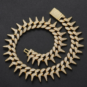 Macro shot of 18K gold plated Cuban link chain with sharp spikes and pave zircon stones