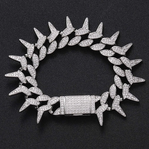 Detailed view of silver spiked Cuban chain with micro-pave zircons and hip hop clasp