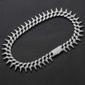 Macro view of spiked Cuban chain with full zircon paving and secure box clasp