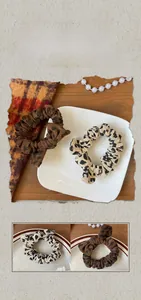 Detailed close-up of leopard print scrunchies with soft texture and elastic design