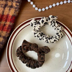 Elegant leopard print hair scrunchies with bow tie detail for vintage autumn styling