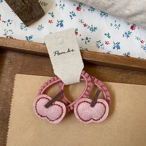 Close-up of pink heart-shaped cherry hair ties with high-elasticity beaded bands