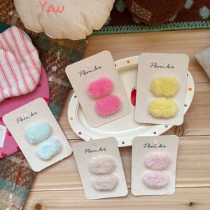 Set of ten colorful plush oval hair clips for girls in pastel pink yellow and blue shades