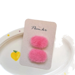 Pair of sweet pink plush hair clips for girls on display card with soft texture finish