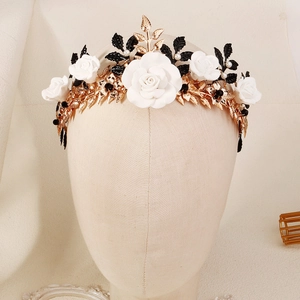 Detail of Halloween floral headband with white roses, black and gold metallic leaves