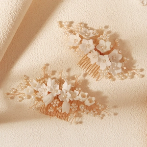 Elegant bridal hair combs set with handmade white flowers and pearls on golden base